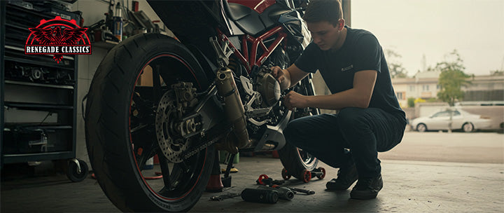 New rider performing basic maintenance on a sportbike in a home garage.