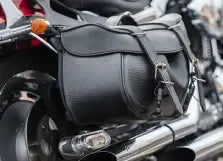 Black leather saddlebag attached to a motorcycle