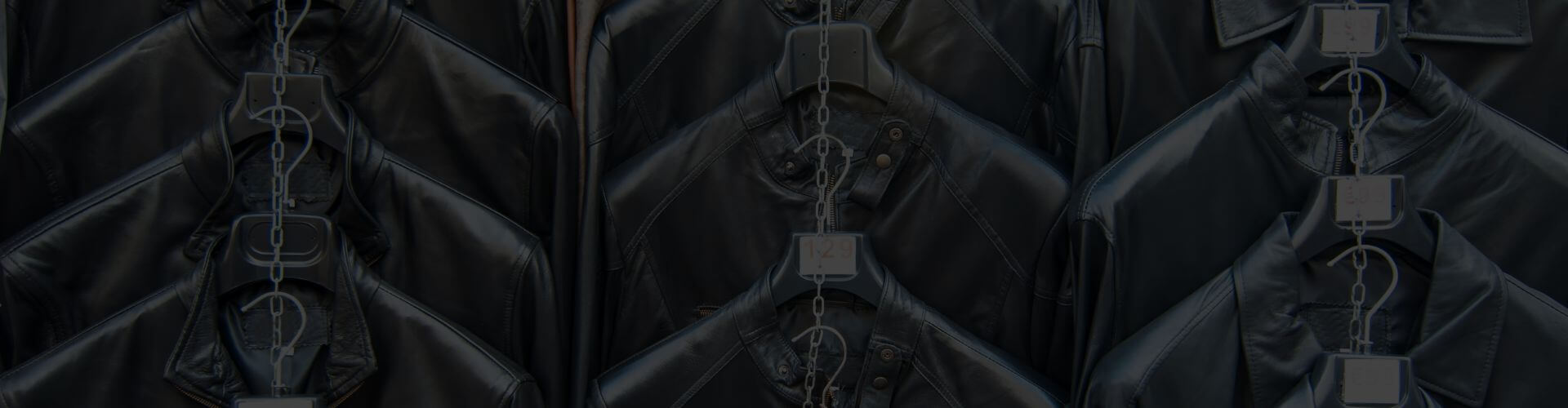Renegade Classics franchise opportunity banner with rows of black leather motorcycle jackets on hangers.