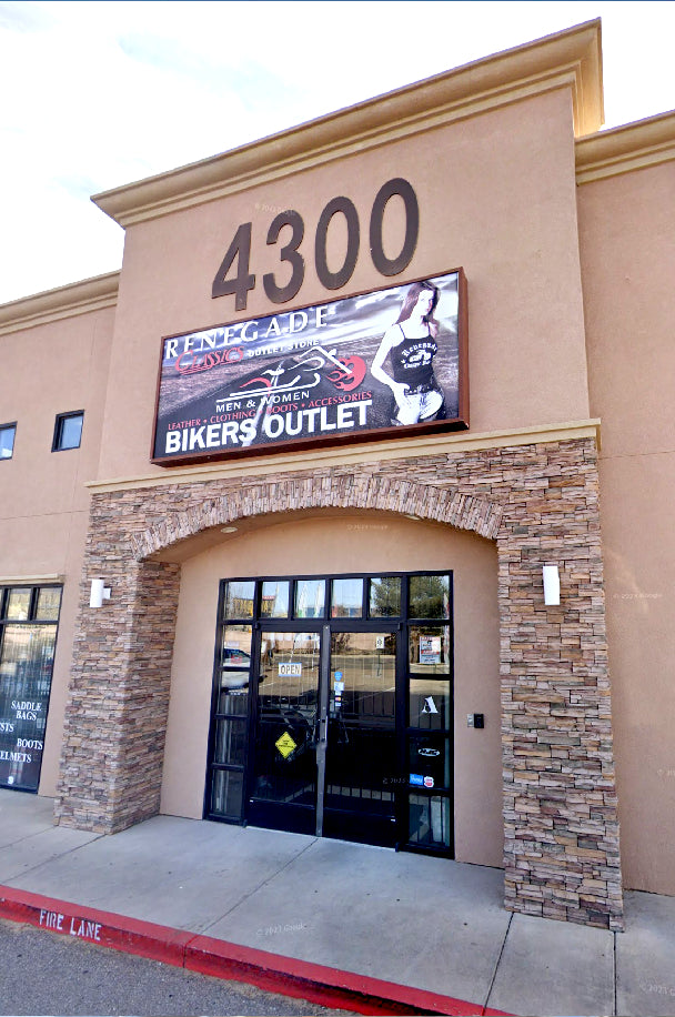 the exterior of "Renegade Bikers Outlet" at building number 4300, with a large sign promoting leather clothing, boots, and accessories for men and women. The storefront has a "FIRE LANE" painted on the curb, and the door sign indicates the store is open.